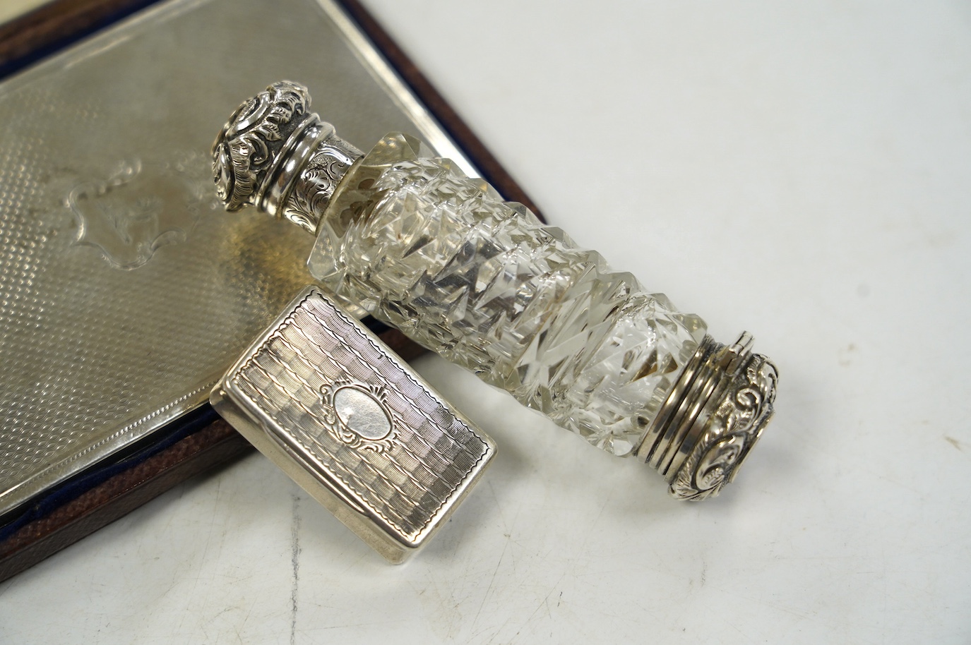 A Victorian silver mounted card purse, by Frederick Marson, Birmingham, 1859, 97mm, in a fitted case, together with a white metal vinaigrette and a white metal mounted cut glass double ended scent bottle, one end with a